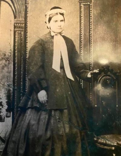 19th century photo of a woman in her 30s wearing a dress