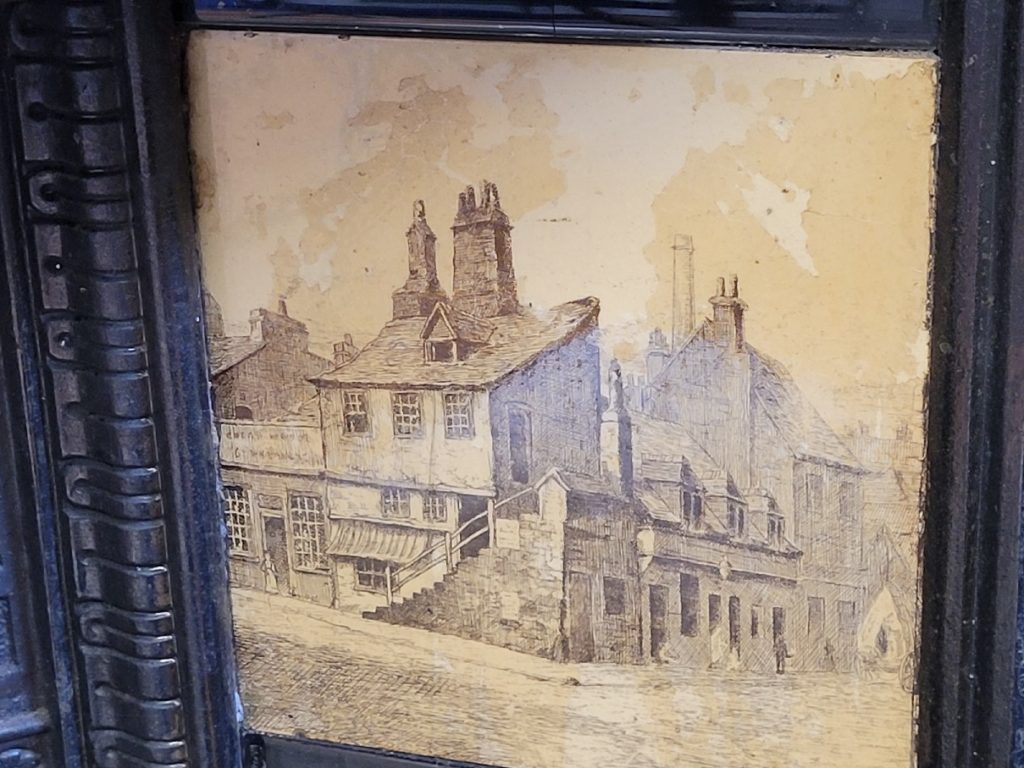 ceramic fireplace decorative insert with painted image - appears to be an old Scottish town