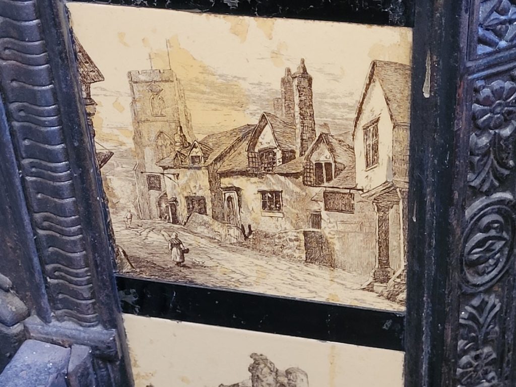 ceramic fireplace decorative insert with painted image - appears to be an old Scottish town