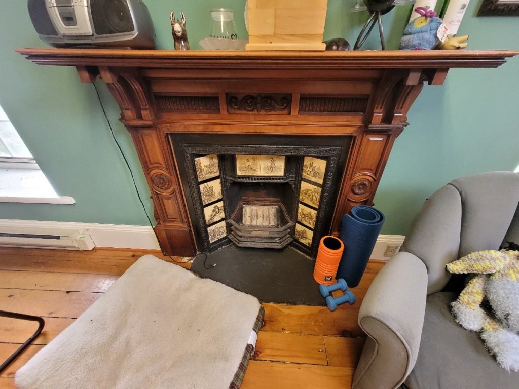 19th century wrought iron fireplace with artistic ceramic inserts