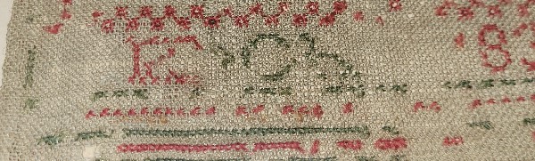 early 19th century cross stitch sampler revealing damage