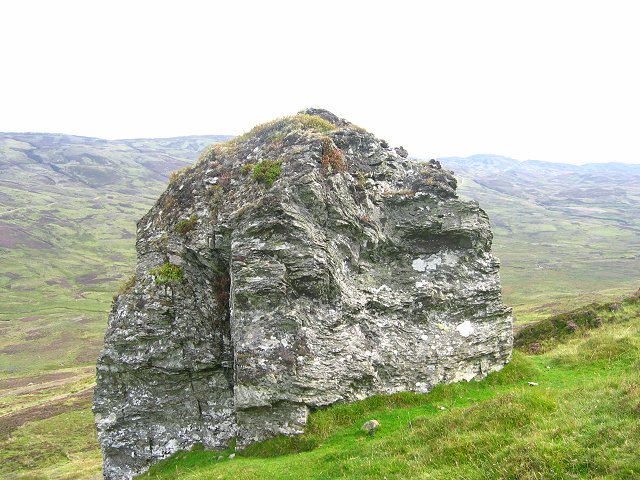large boulder on the side of a steep hill in the Highlands of Scotland