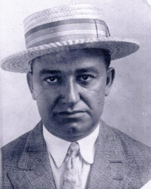 head shot of an Italian man in a suit and dress hat